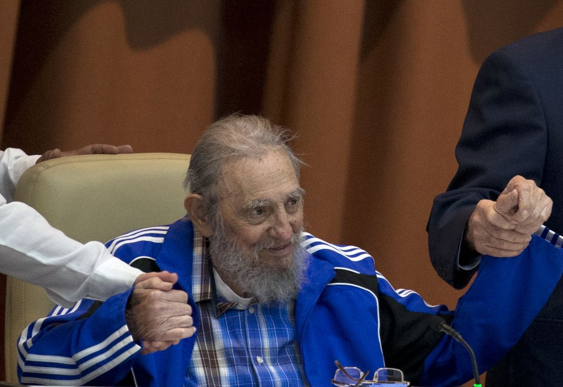 In this April 19, 2016 file photo, Fidel Castro sits as he clasps hands with his brother, Cuban President Raul Castro, right, and second secretary of the Central Committee, Jose Ramon Machado Ventura moments before the playing of the Communist party hymn during the closing ceremonies of the 7th Congress of the Cuban Communist Party, in Havana, Cuba. (Cubadebate via AP)
